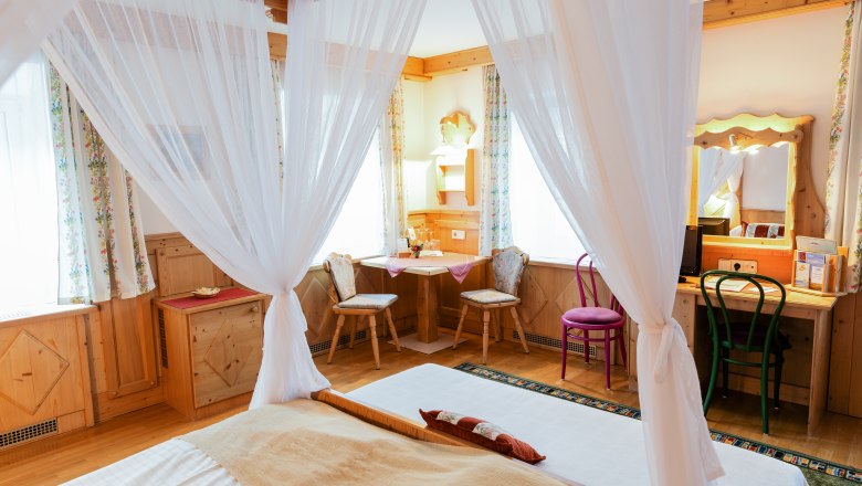 Double room Cat. B, © Scharfegger´s Raxalpen Resort Cozy double room with four-poster bed, wooden furniture and desk.