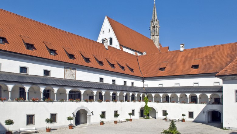 Inner courtyard of Gaming Charterhouse with arcades and red tiled roof.