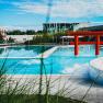 Exterior view of the Linsberg Asia Therme with pool and red torii.