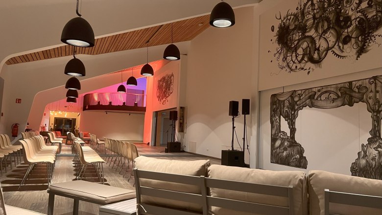 Modern foyer with seating and artistic murals.