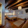 Comfortable room with wooden floor, double bed, shower and modern furnishings.