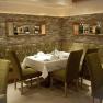 Elegant restaurant with laid table and green chairs.