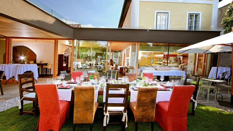 Elegant restaurant with an outdoor table surrounded by modern buildings.