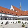 Inner courtyard of Gaming Charterhouse with arcades and red tiled roof.