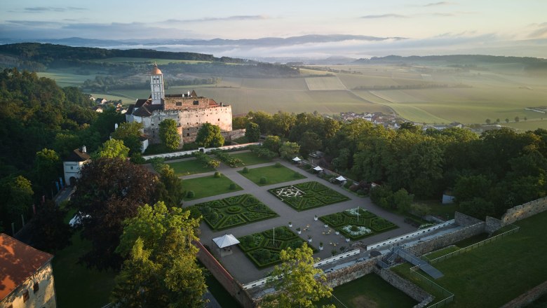 Aerial view of Schallaburg Castle with gardens and surrounding landscape.