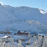 Winter landscape with snow-covered mountains and buildings on the Hochkar.