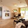 Elegant wellness area with fireplace, armchairs and glass door.