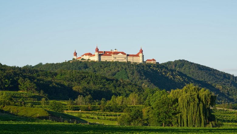 Göttweig Benedictine Abbey on a hill with a green landscape in the foreground.