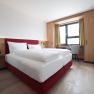 Double bed in bright room with window