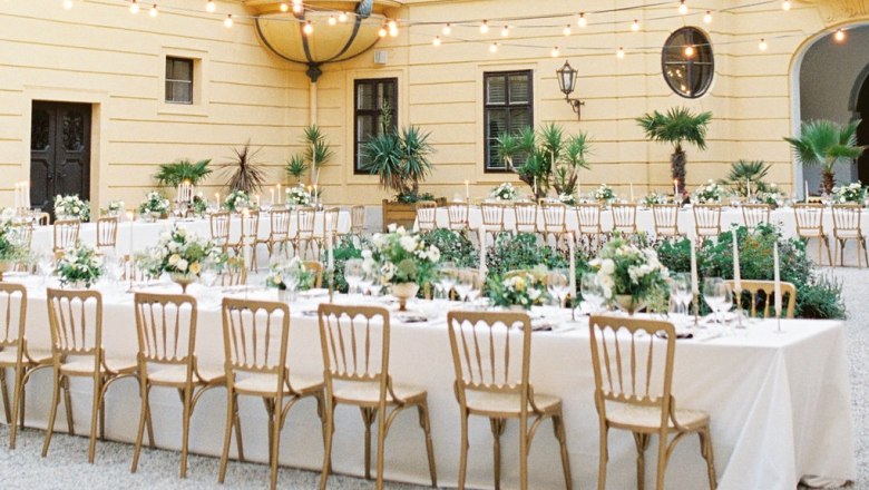 Inner courtyard of Schloss Eckartsau with festively laid tables and fairy lights.