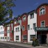 Exterior view of the Restaurant-Hotel Wallner with red and white fa&ccedil;ade.