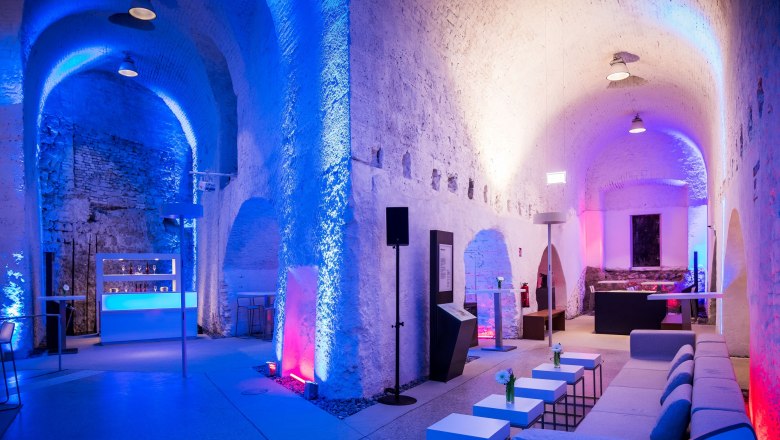 Interior view of the casemates in Wiener Neustadt with blue and red lighting.
