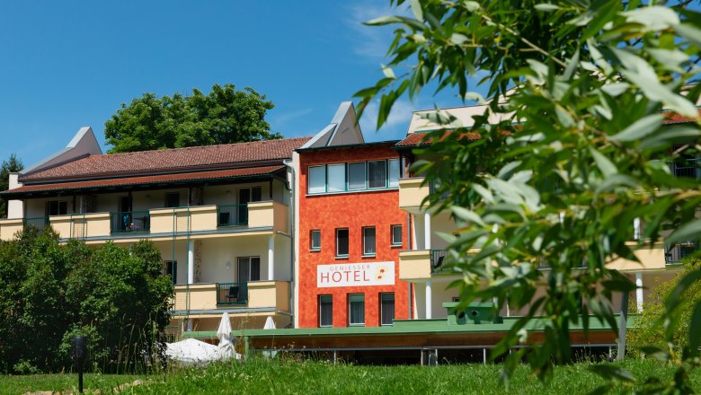Exterior view of the Hotel-Restaurant Liebnitzm&uuml;hle with green lawn and trees in the foreground.