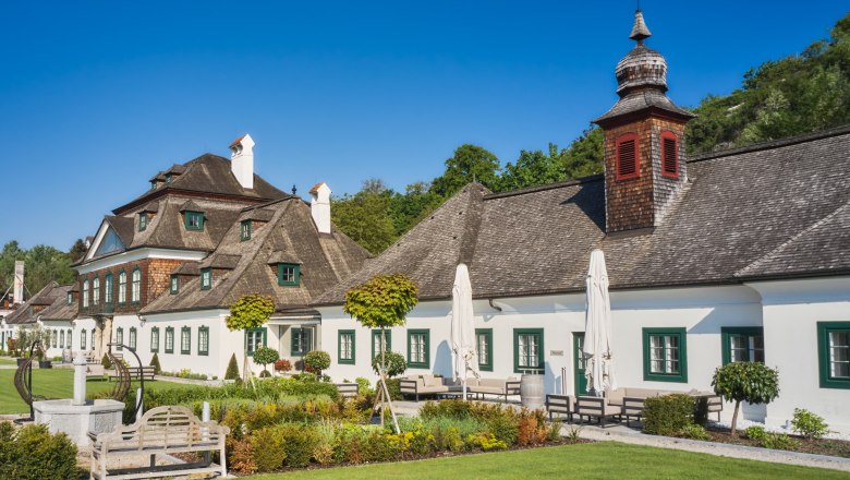 Schloss Luberegg with its well-tended garden and blue sky.