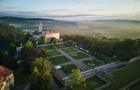 Aerial view of Schallaburg Castle with gardens and surrounding landscape.