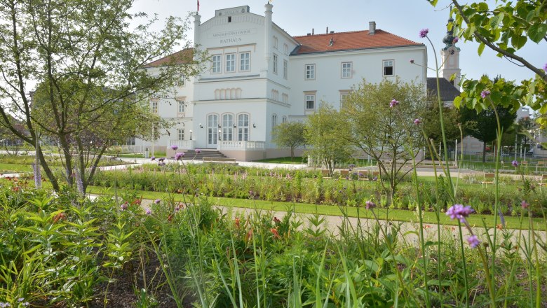 The Minoritenkloster in Tulln with a well-tended garden in the foreground.