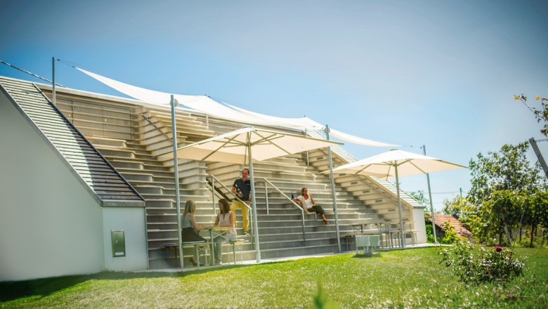 Modern terrace with parasols and people chatting.