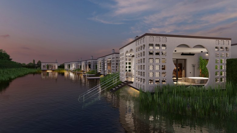 Modern villas on the water at sunset.