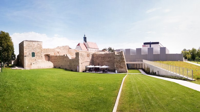 Historic casemates with modern architecture and green space.