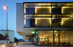 Modern hotel building with glass façade at dusk.