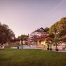 Large house with garden and pool at sunset.