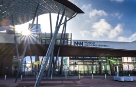Entrance to the Museum Niederösterreich with modern architecture and rays of sunshine.