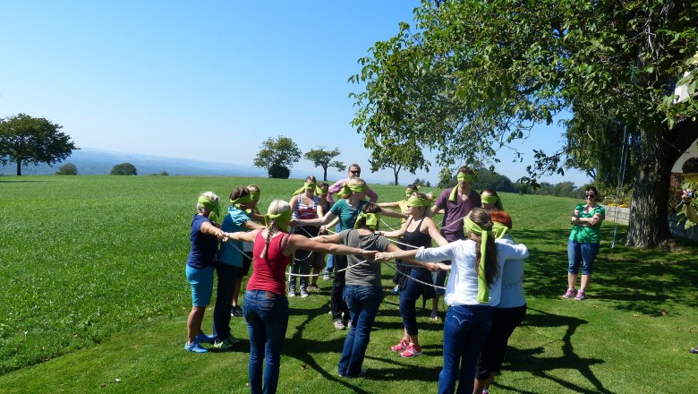 Group of blindfolded people during an outdoor team exercise.