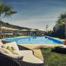 Outdoor pool at the Steigenberger Krems with sun loungers and parasols.