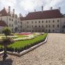 Schloss Thalheim with well-kept garden and gravel path.