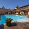 Outdoor pool at Hotel Schloss D&uuml;rnstein with sun loungers and parasols.