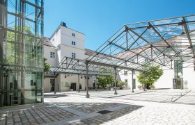Inner courtyard of the Hotel Altes Kloster with glass roof and modern design.