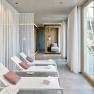 Modern spa area with loungers and large windows.