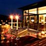 Evening restaurant terrace with candlelight and wine glasses.