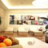 A modern relaxation room with loungers, plants and a fruit bowl in the foreground.