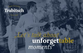A waiter serves at an elegant event. Text: "Let's talk about unforgettable moments". Trabitsch Catering logo top left.