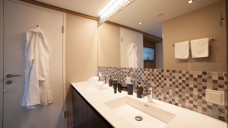 Bathroom with washbasin and bathrobe