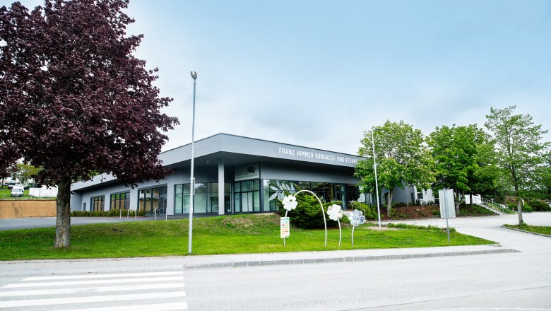 Franz Himmer Congress and Event Center with trees and walkway in the foreground.