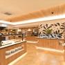 Modern buffet area with wooden decor and plants.