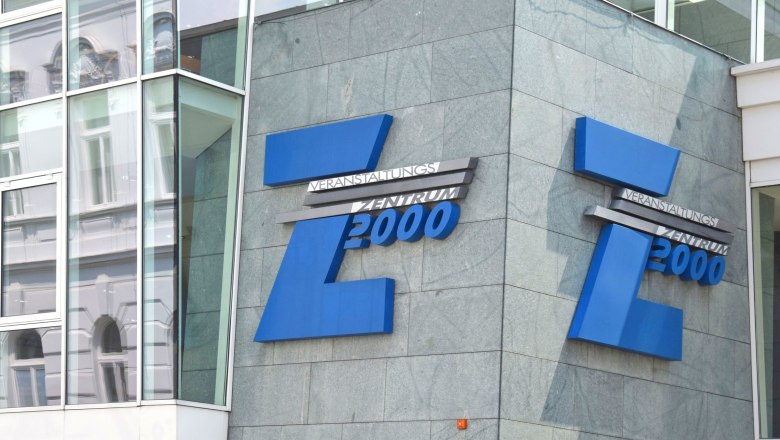 Entrance to the Z2000 event center with blue logo on grey fa&ccedil;ade.