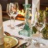 Elegant table decoration with glasses, candlesticks and flowers in the Steigenberger Krems Restaurant.