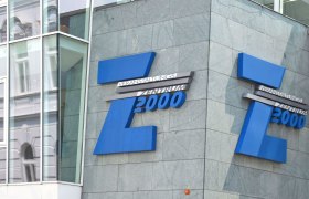 Entrance to the Z2000 event center with blue logo on grey fa&ccedil;ade.
