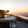 Infinity pool at Hotel Schachner with a view of the river landscape at sunset.