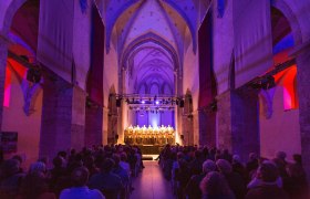 Interior view of the Minorite Church in Krems during a concert with illuminated choir.