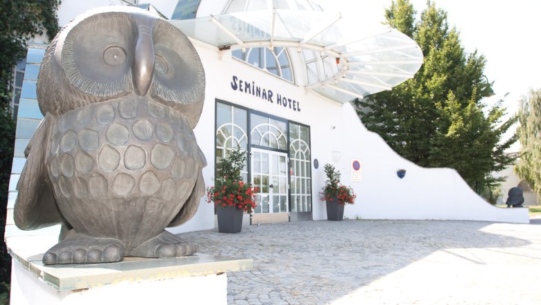 Entrance to a seminar hotel with owl sculpture.