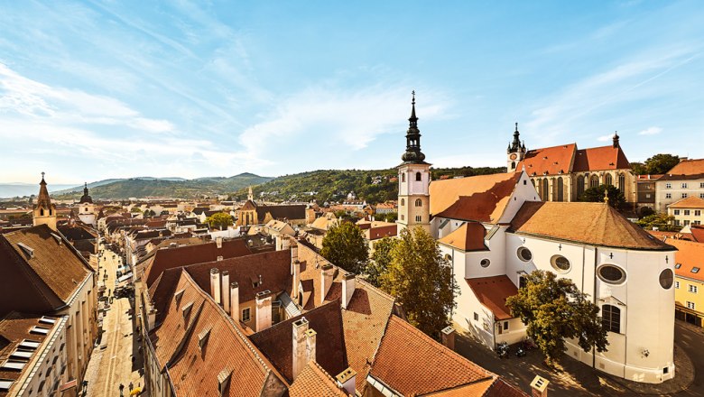 Panoramic view of the old town of Krems with churches and red roofs.