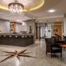 Hotel reception with bar and seating area.