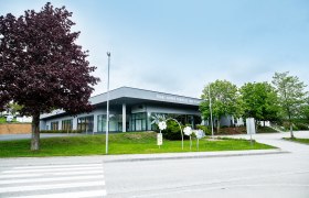 Franz Himmer Congress and Event Center with trees and walkway in the foreground.